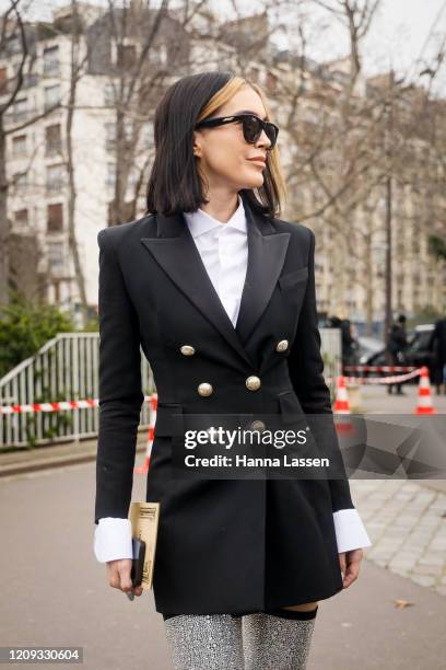 Brittany Xavier wearing black Balmain blazer, silver knee high boots and sunglasses outside the Balmain show during the Paris Fashion Week Womenswear...