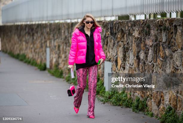 Jessica Minkoff is seen wearing pink puffer jacket, Chanel bag, pants with snake print outside Loewe during Paris Fashion Week - Womenswear...