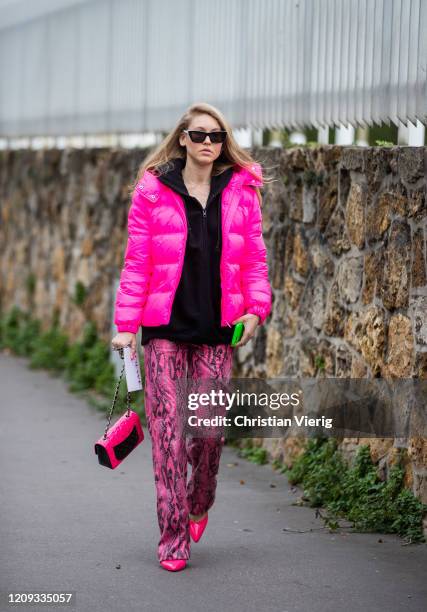 Jessica Minkoff is seen wearing pink puffer jacket, Chanel bag, pants with snake print outside Loewe during Paris Fashion Week - Womenswear...