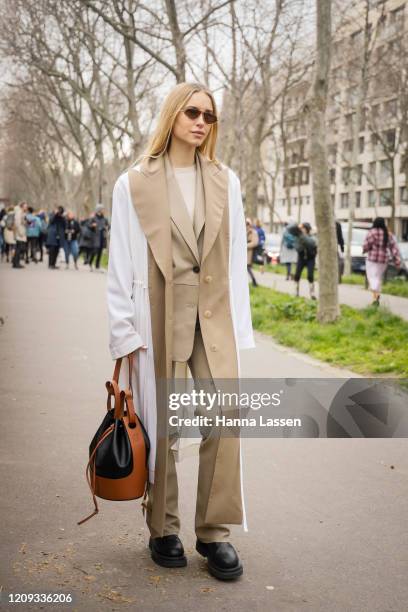 Pernille Teisbaek wearing Loewe coat and brown bag outside the Loewe show during the Paris Fashion Week Womenswear Fall/Winter on February 28, 2020...