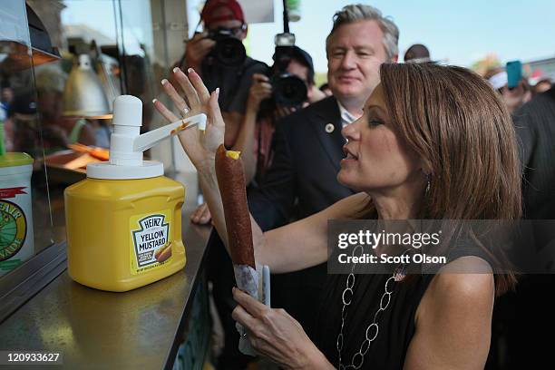 Minnesota Congresswoman and Republican presidential candidate Michele Bachmann puts mustard on a corn dog at the Iowa State Fair August 12, 2011 in...