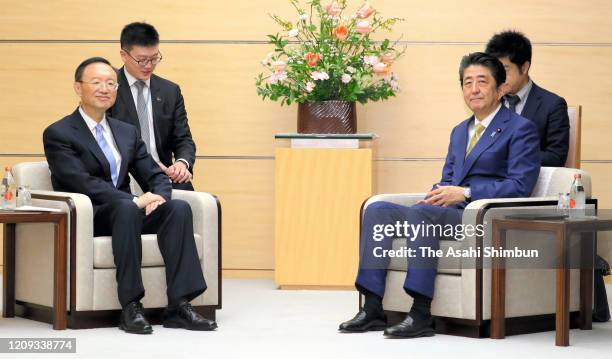 China's Central Foreign Affairs Commission Director Yang Jiechi and Japanese Prime Minister Shinzo Abe talk during their meeting at the prime...