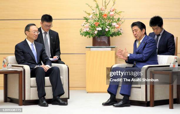 China's Central Foreign Affairs Commission Director Yang Jiechi and Japanese Prime Minister Shinzo Abe talk during their meeting at the prime...