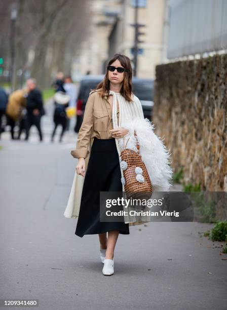 Natasha Goldenberg is seen wearing skirt, cape, brown net bag, camel button shirt outside Loewe during Paris Fashion Week - Womenswear Fall/Winter...