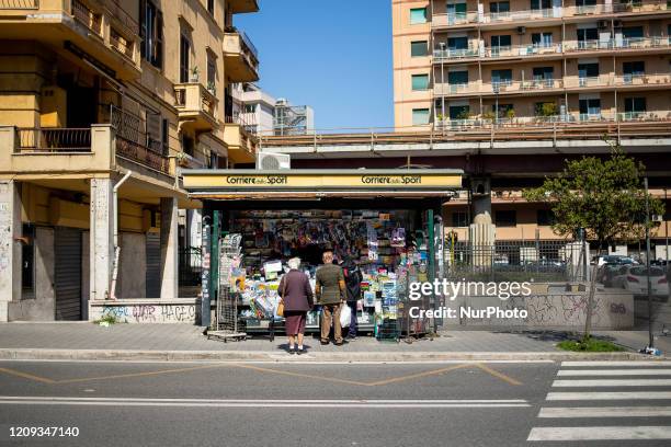 Newsstand open with some people who are preparing to buy newspapers on L'aquila street, on April 7, 2020 in Rome. The Italian government has issued...