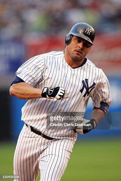 Jason Giambi of the New York Yankees runs the bases after hitting a home run in the first inning against the New York Mets at Yankee Stadium on June...