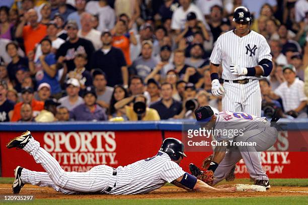 Jason Giambi of the New York Yankees is tagged out by Julio Franco of the New York Mets in the first inning at Yankee Stadium on July 2, 2006 in New...