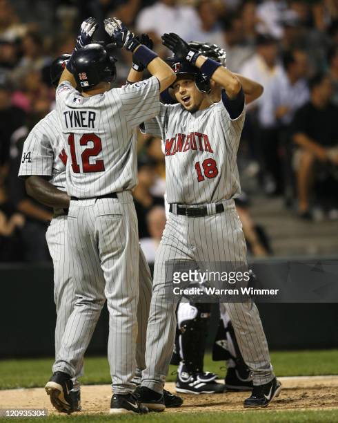 Jason Tyner of the Minnesota Twins, left, celebrates with Jason Bartlett at Wrigley Field Chicago, Illinois, USA, July 20, 2006 as the Minnesota...