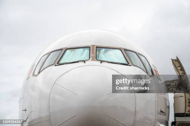 nose of large white commercial aircraft - boeing 777 stock pictures, royalty-free photos & images