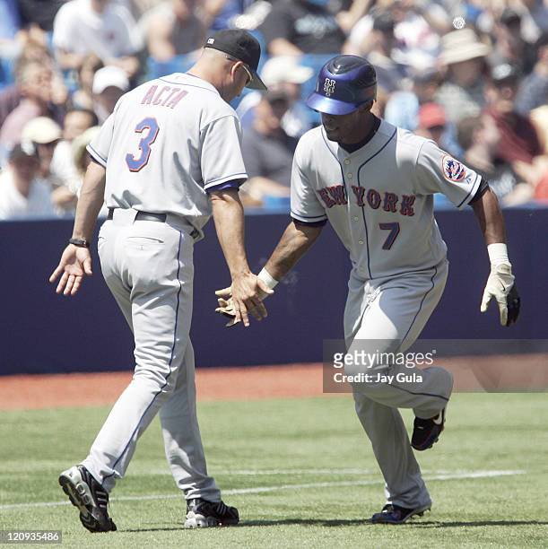 New York Mets SS Jose Reyes is congratulated by 3rd base coach Manny Acta after leading off the game with a HR in action vs the Toronto Blue Jays at...