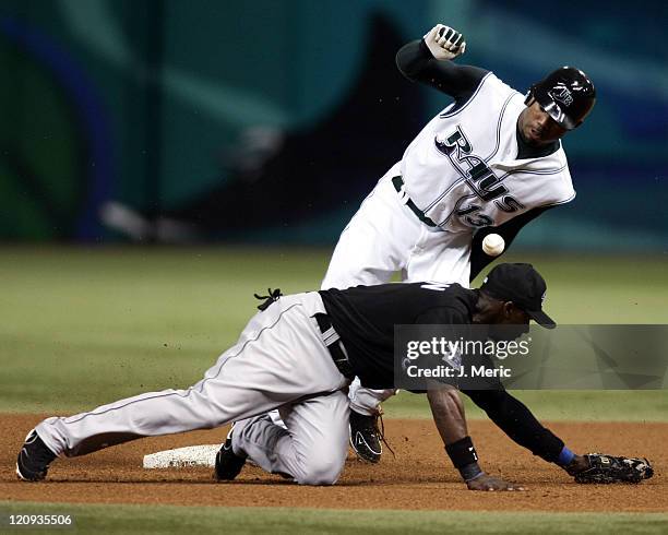 Tampa Bay Devil Rays outfielder Carl Crawford slides safely into second with a stolen base as Toronto Blue Jays infielder Orlando Hudson tries to...