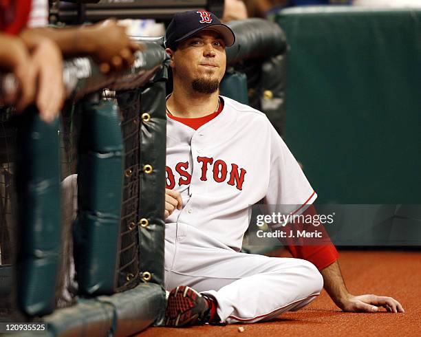 Boston Red Sox pitcher Josh Beckett sits at the end of the dugout and watches Wednesday night's game against Tampa Bay Devil Rays at Tropicana Field...