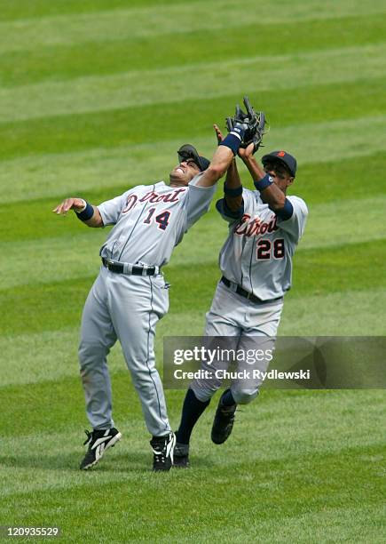 Detroit Tigers' 2nd Baseman, Placido Polanco and Center Fielder, Curtis Granderson, almost collide during the game against the Chicago White Sox...