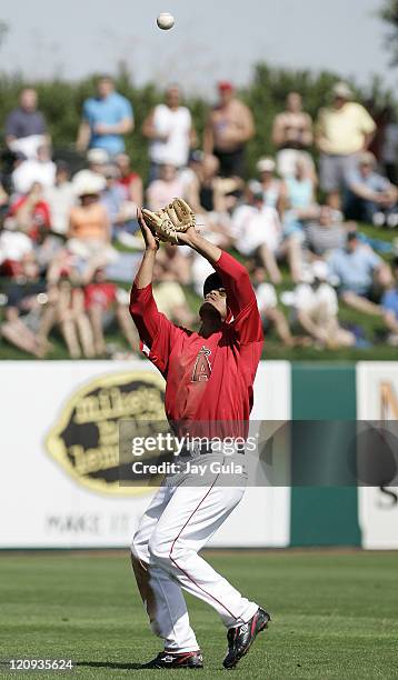 Los Angeles Angels SS Orlando Cabrera settles under an infield popup in Cactus League action vs the Seattle Mariners at Tempe Diablo Stadium in...