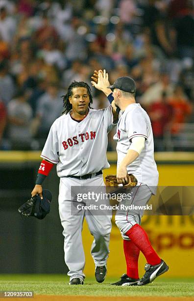 Boston Red Sox players, Manny Ramirez and Trot Nixon, celebrate their team's 3-0 win over the game against the Chicago White Sox July 23, 2005 at...