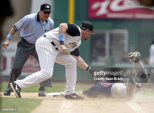 Minnesota Twins Lew Ford approaches first base and attempts to slide under the tag of Pittsburgh Pirates Sean Casey during action at PNC Park in...