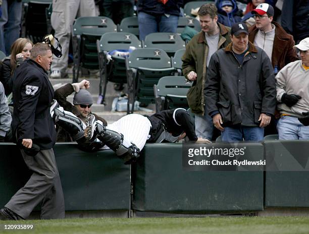 Chicago White Sox' Catcher, A.J. Pierzynski tumbles into the stands trying to catch a foul pop during their game against the Minnesota Twins April 7,...