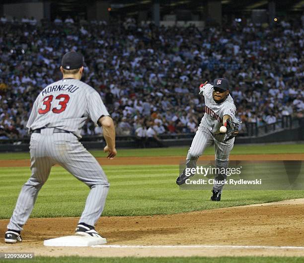 Minnesota Twins 2nd Baseman, Luis Castillo, flips a throw to Justin Morneau to get the hitter during the game against the Chicago White Sox July 24,...