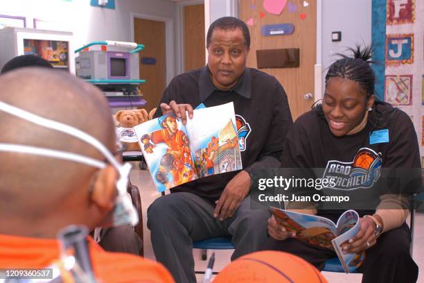 Former NBA player, Jamaal Wilkes and Nikki Teasley of the Los Angeles Sparks read to children during a Read to Achieve Hospital Visit as part of 2004...