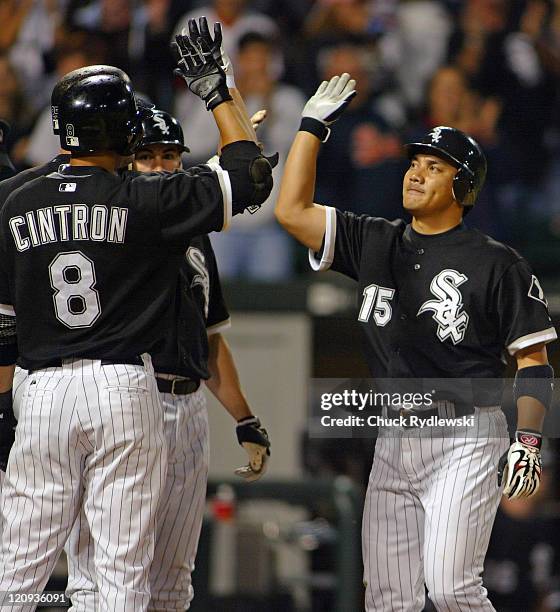 Chicago White Sox' 2nd Baseman, Tadahito Iguchi, is greeted by teammates after hitting a 9th inning, game tying grand slam home run during their game...