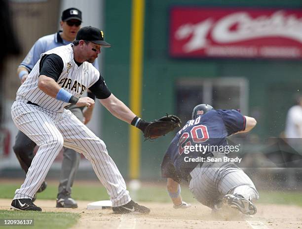 Minnesota Twins Lew Ford approaches first base and attempts to slide under the tag of Pittsburgh Pirates Sean Casey but is tagged out during action...