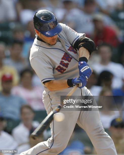 Paul Lo Duca of the New York Mets, makes contact with a Greg Maddux pitch at Wrigley Field in Chicago, Illinois on July 14, 2006. The New York Mets...