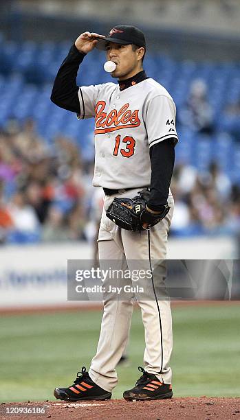 Baltimore Orioles P Rodrigo Lopez blows a bubble and adjusts his cap after surrendering 3 runs in the 1st inning during tonight's game vs the Toronto...