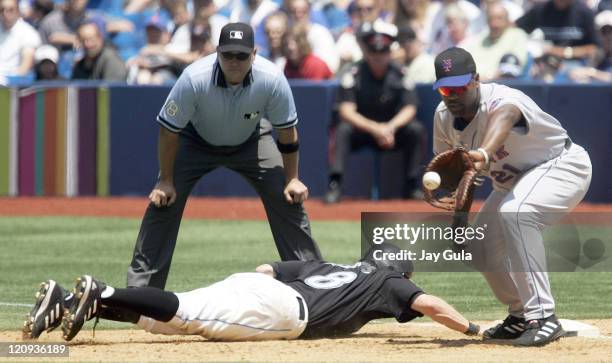 New York Mets Carlos Delgado awaits the throw from P Steve Trachsel but it was not in time to get Toronto Blue Jays Russ Adams in action at Rogers...