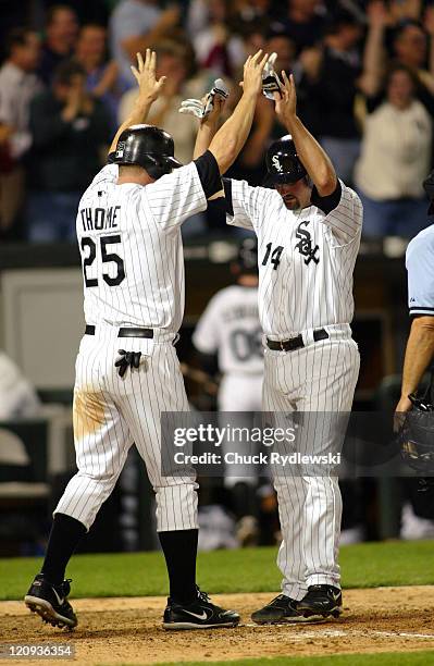 Chicago White Sox ' Paul Konerko and Jim Thome celebrate Joe Crede's 7th inning grand slam homer during their game against the Seattle Mariners May...