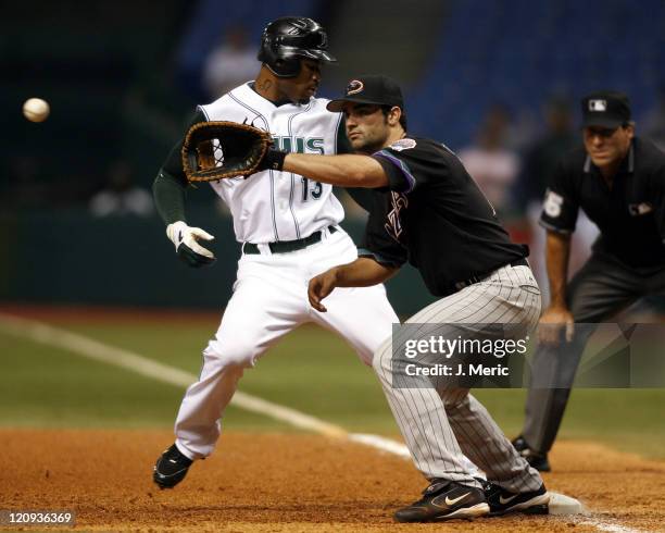 Arizona first baseman Conor Jackson prepares for this throw as Tampa Bay's Carl Crawford hurries back to first during Tuesday night's action at...