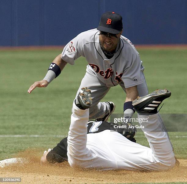 Detroit 2nd baseman Placido Polanco tags out a sliding Eric Hinske at 2nd base in the Detroit Tigers vs Toronto Blue Jays game in Toronto, Canada on...