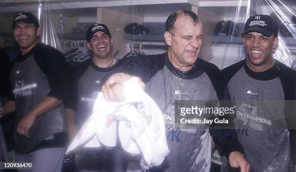 Manager Joe Torre is doused in champagne as his New York Yankees celebrate in their clubhouse after clinching their 9th consecutive American League...