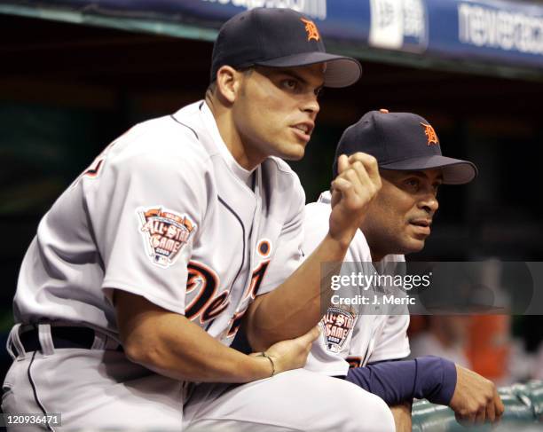 Detroit Tigers catcher Ivan Rodriguez and hitting coach Bruce Fields have a discussion during Thursday night's game against the Tampa Bay Devil Rays...