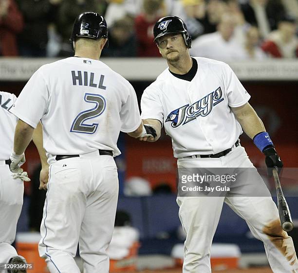 Toronto Blue Jays Aaron Hilll is congratulated by teamamate Gregg Zaun after hitting his 2nd HR of the season in MLB action vs the Detroit Tigers at...