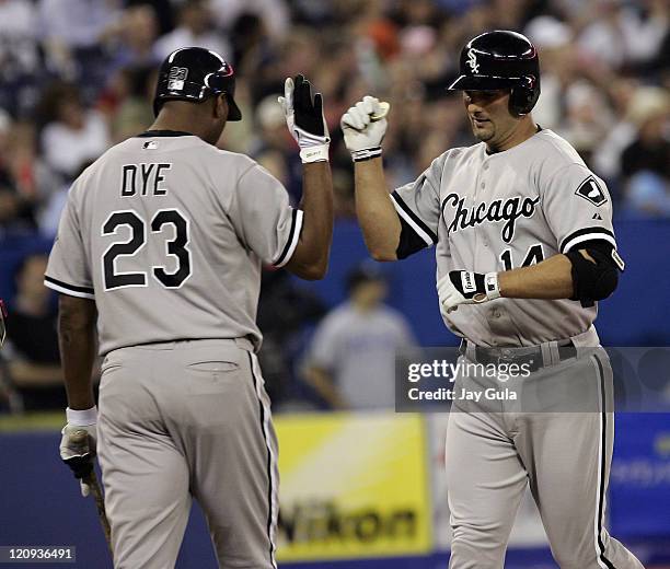 Paul Konerko is congratulated by Jermaine Dye after slugging a solo HR for the Chicago White Sox against the Toronto Blue Jays at Rogers Centre in...