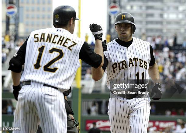Pittsburgh Pirates Humberto Cota is greeted by his teammate Freddy Sanchez after hitting a game tieing solo home run in the bottom of the 9th against...