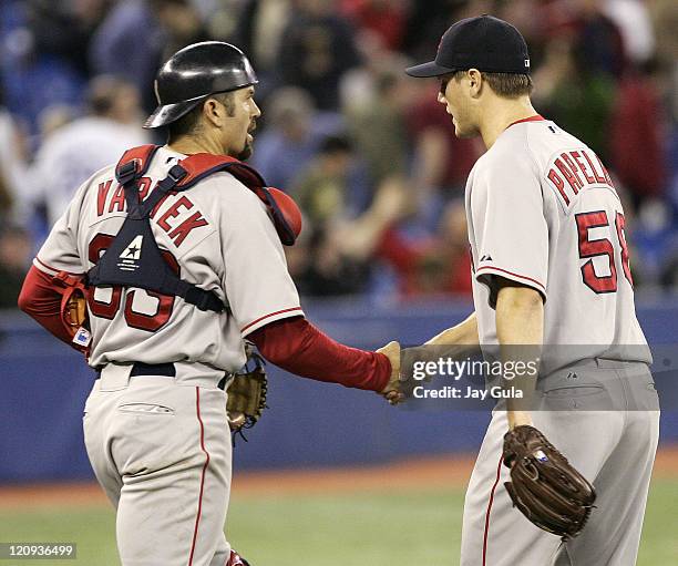 Boston Red Sox closer Jonathan Papelbon is congratulated by C Jason Varitek after Papelbon recorded his 4th save in the Red Sox 5-3 victory over the...