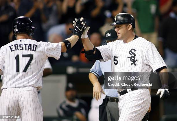 Chicago White Sox' DH, Jim Thome is greeted at home plate by teammate, Darin Erstad after hitting a 3-run homer during their game versus the Oakland...