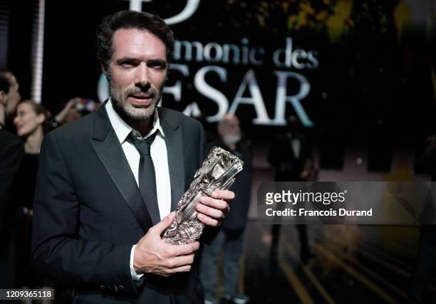 Nicolas Bedos poses with the Best Original Screenplay award for the movie 'La Belle epoque' during the Cesar Film Awards 2020 Ceremony at Salle...
