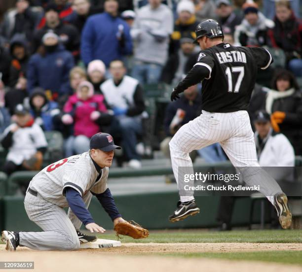 Minnesota Twins' 1st Baseman, Justin Morneau tags 1st base just ahead of Darin Erstad during their game against the Chicago White Sox April 7, 2007...