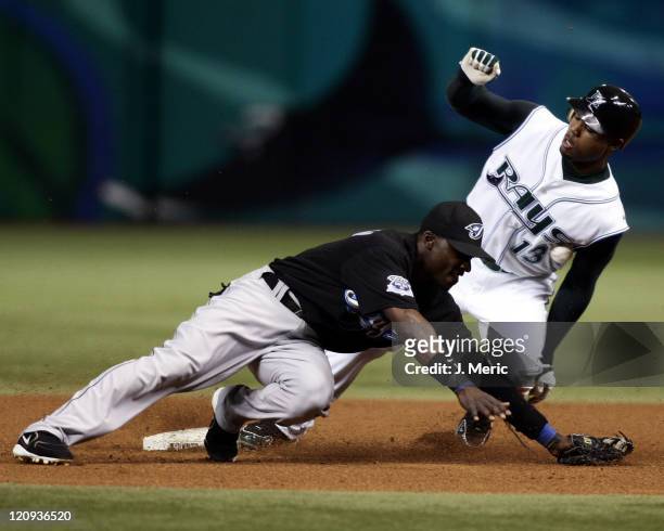 Tampa Bay Devil Rays outfielder Carl Crawford slides safely into second base with a steal as Toronto Blue Jays infielder Orlando Hudson tries to make...