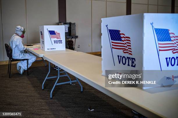 Elections Chief Inspector Mary Magdalen Moser runs a polling location in Kenosha, Wisconsin, in full hazmat gear as the Wisconsin primary kicks off...