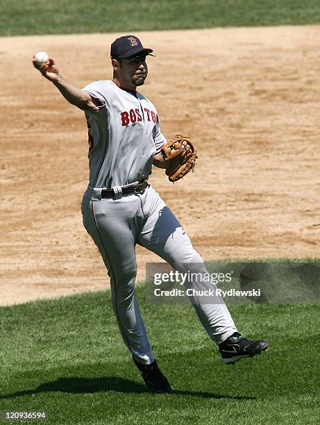 Boston Red Sox' 3B, Mike Lowell, makes an off-balance throw to get the hitter at first during the game against the Chicago White Sox July 9, 2006 at...