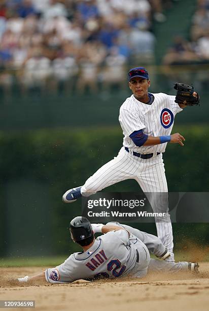 Ronny Cedeno, Chicago Cub shortstop, avoids a sliding Xavier Nady at Wrigley Field in Chicago, Illinois on July 14, 2006. The New York Mets over the...