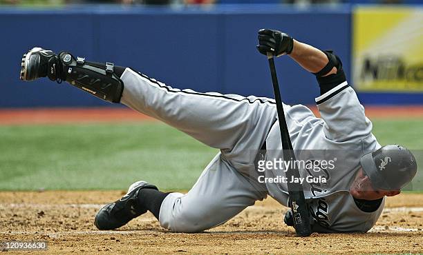 Chicago White Sox DH Jim Thome ends up in an awkward position on the ground after backing away from an inside pitch vs the Toronto Blue Jays at...