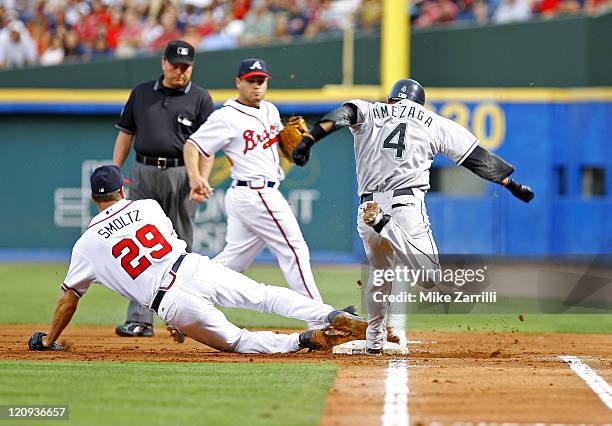 Atlanta Braves P John Smoltz makes the defensive play of the game to get the out at 1B against Marlins SS Alefredo Amezaga during the game between...