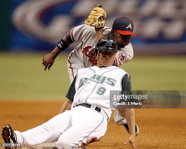 Tampa Bay's Tomas Perez slides safely into third as Atlanta's Wilson Betemit was late with the tag in Friday night's action at Tropicana Field in St....