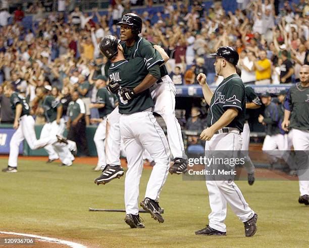 Tampa Bay's Josh Paul is congratulated by B.J. Upton after Paul scored the winning run in Friday night's action against Seattle at Tropicana Field in...