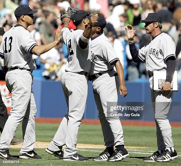 Yankees Mariano Rivera and 1B coach Tony Pena congratulate one another after the Yankees 3-1 victory over Toronto during the New York Yankees vs...