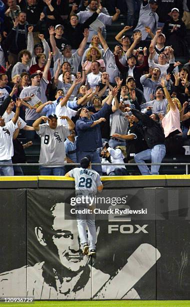 Seattle Mariners' Left Fielder, Raul Ibanez, leaps but can only watch Pablo Ozuna's two-out, game-tying pinch hit home run in the 9th inning land in...